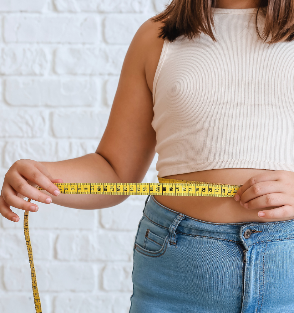 Frau mit Übergewicht und Maßband um den Bauch